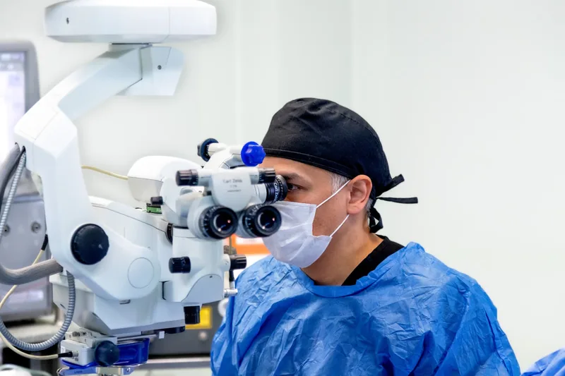 Dr. Michael Rod realizando cirugía de catarata con microscopio quirúrgico